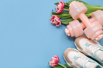 Composition with dumbbells, shoes and tulip flowers for International Women's Day on color background