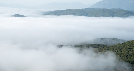 Mountain tops covered in a layer of mist and fog at dawn. Nature landscape