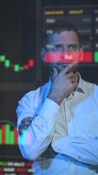 Caucasian bearded man analyzes stock charts on a virtual screen. HUD menu.