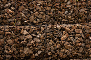 stone wall covered with metal construction grid, background