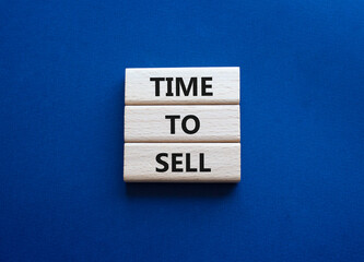 Time to Sell symbol. Concept words Time to Sell on wooden blocks. Beautiful deep blue background. Business and Time to Sell concept. Copy space.
