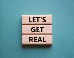 Lets get real symbol. Concept words Lets get real on wooden blocks. Beautiful grey green background. Business and Lets get real concept. Copy space.