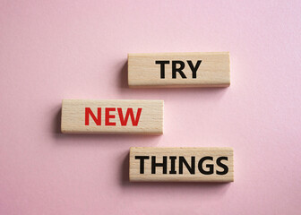 Try new Things symbol. Concept words Try new Things on wooden blocks. Beautiful pink background. Business and Try new Things concept. Copy space.