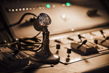 Old microphone, vintage mixer console in the recording room, command center equipment