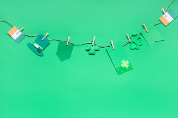 Paper garland with clover, leprechaun hat and Irish flags for St. Patrick's Day celebration on...