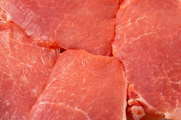 Raw pork pieces isolated on a white background.