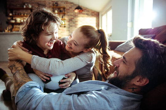 Happy young family playing together at home