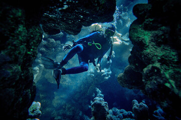 Fototapeta na wymiar The beauty of the underwater world - a scuba diver got lost in an underwater cave - scuba diving in the Red Sea, Egypt