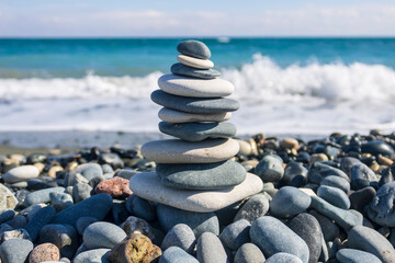 Zen stone pyramid on sea beach