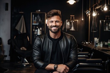 Obraz na płótnie Canvas Portrait of a smiling male hairdresser in modern salon