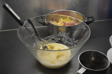 Preparing a healthy and wholesome meal, butter with milk with a whisk placed in a large glass container.