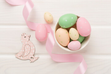 Easter eggs and decoration on wooden background, top view