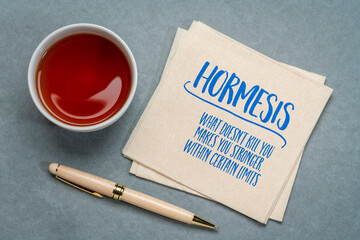 hormesis concept on a napkin, biological phenomenon where exposure to low doses of a stressor or...