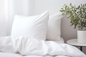 Modern white bedroom interior design details. Comfortable bed with soft white pillows and bedding in bed