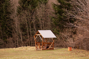 wooden gazebo for a picnic near the forest
