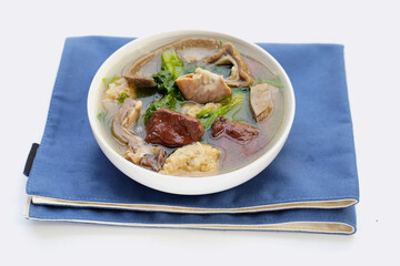 Bowl of pork blood soup on white background.