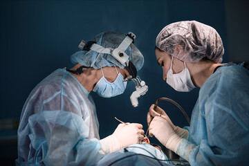 A shot of an emergency and a serious accident in the operating room, a team of surgeons makes an...