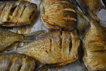 Delicious and healthy, baked fish, Carassius with lemon on a black baking sheet with white...