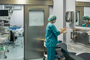 The doctor washes his hands before surgery. Sterility concept. A professional surgeon washes his...