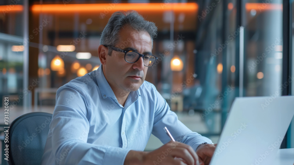 Poster confident individual at a workstation with multiple computer monitors in a modern office.