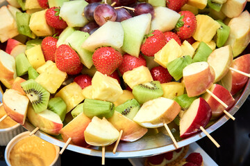 Fruit skewers, fruit salad, cupcakes on candy bar at the party show