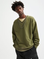 Handsome, young African American male in olive green sweatshirt with black cargo pants, casual style