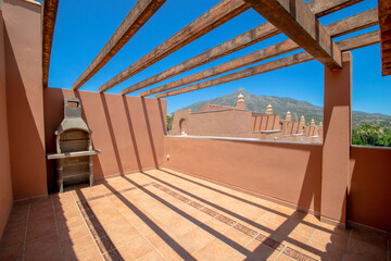 a mediterranean rooftop terrace with barbecue and mountain views in luxury holiday home in Marbella