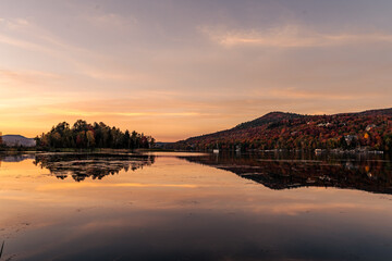 Colorful autumn evening reflecting in lake. Colorful autumn sunset in mountain lake.