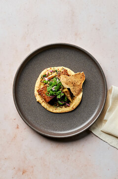 Slow cooked spice-crusted lamb shoulder, yellow fava puree, warm artichoke, lentil & broad bean salad, soft herbs, cumin wafer