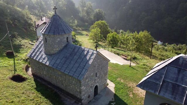 Drone view over monastery of St. Michael the archangel with greenery and sunlight in Durmitor park