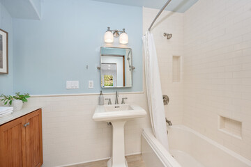 Bathroom with tub, mirror, and sink