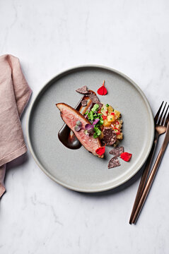 Roasted duck breast, braised pineapple & Mexican green chilli salsa, sour cherry glaze, petit herb garden, blue corn tostada crisps