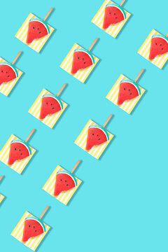 Modern retro color theme pattern of watermelon graphics against an aqua blue background, with negative copy space.