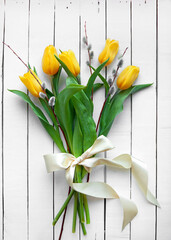 Bouquet of yellow tulip flowers on a white vintage background. Top view, flat lay.