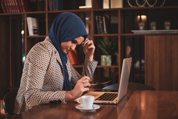 Muslim Business woman or female student with hijab under stress from too much work in the office