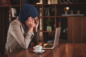 Muslim Business woman or female student with hijab under stress from too much work in the office - obrazy, fototapety, plakaty