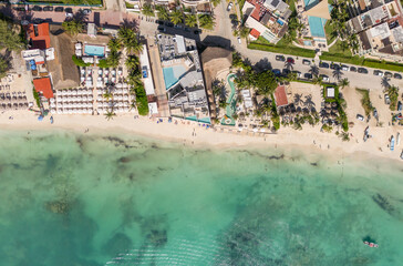 Top down aerial view of Caribbean white sand beach with roof top and swimming pool on a sunny day in Playa del Carmen 