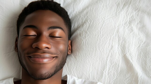 African american man, 20, in white clothes, peacefully sleeping on white bed with soft blanket