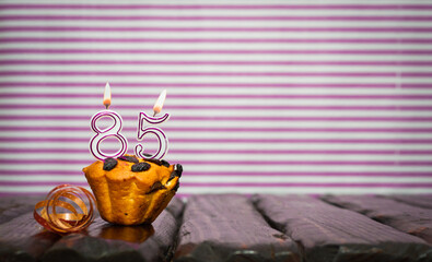 Birthday number 85. Date of birth with number of candles, copy space. Anniversary background with...