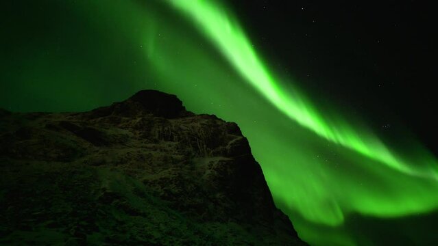Norway Lofoten Islands winter  snow-covered geography northern lights at night green colored aurora borealis in the sky