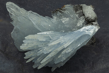 Macro shot of barite crystal formation with translucent blades on dark background