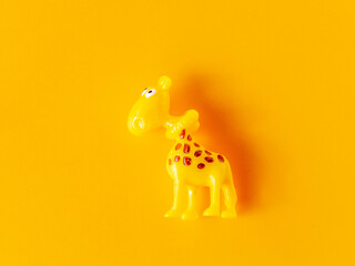 Giraffe toy on yellow