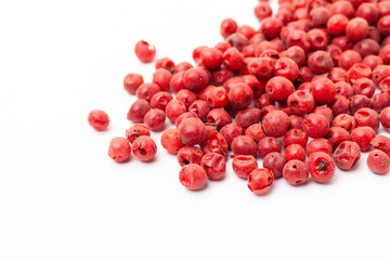 Red peppercorns on white background. Organic spice. Dry red pepper grain. 