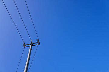 Power electric pole with line wire on colored background close up, photography consisting of power...