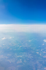 View from the airplane window at a beautiful cloudy sky and the airplane wing