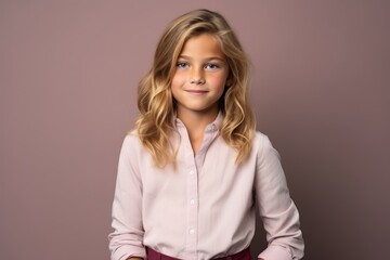 Portrait of a cute little girl with long blond hair. Studio shot.