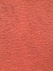 Textura de un revoque texturado color rojizo