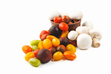 Colorful tomatoes and mushrooms isolated on white background. Top view.