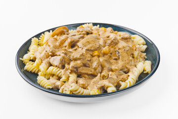 pasta with meat and cream sauce on a plate on a white background
