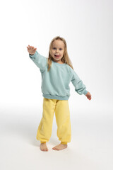 Portrait of beautiful cute little toddler girl. Child with funny face. Pretty smile kid in studio on white background. High quality photo